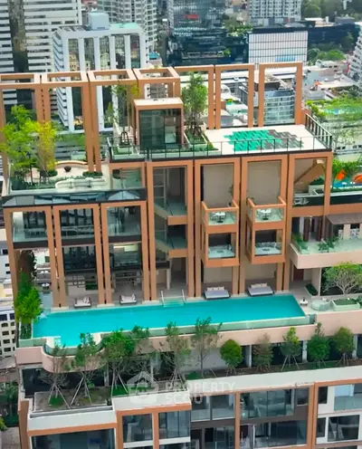 Luxurious high-rise building with rooftop pool and lush greenery in urban setting.
