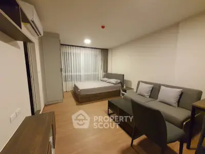 Modern studio apartment with cozy furnishings and wooden flooring