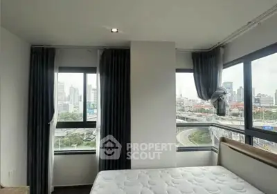 Modern bedroom with city view and large windows in urban apartment