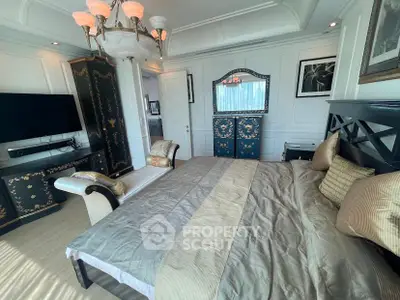 Luxurious bedroom with elegant decor and stylish furniture, featuring a large bed and ornate cabinetry.