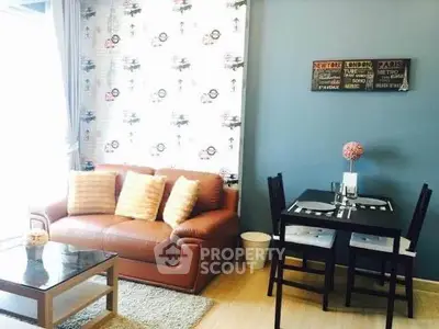 Charming living room with cozy sofa and stylish dining area, perfect for modern living.