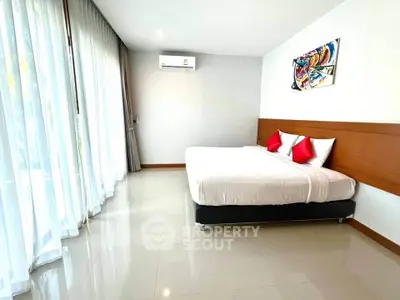 Spacious modern bedroom with large windows and stylish decor