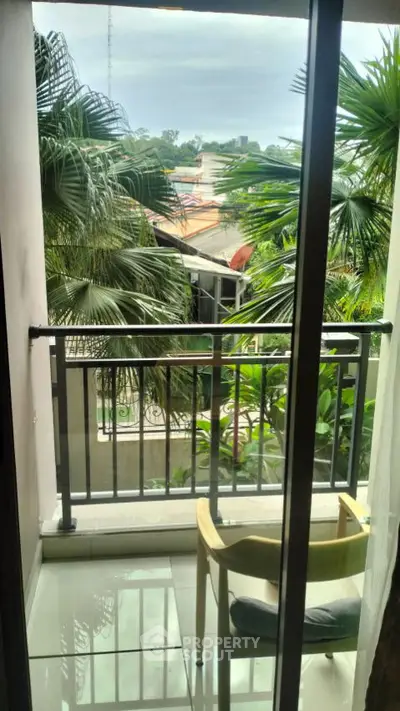 Charming balcony with lush green view, perfect for relaxation and enjoying nature's tranquility.