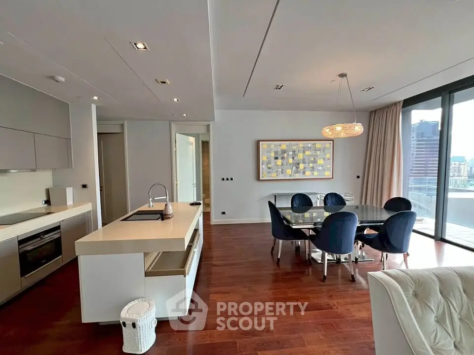Luxurious open-plan living and dining area with modern kitchen and city view balcony.