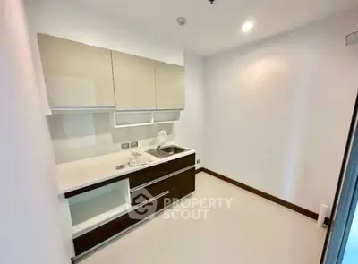 Modern minimalist kitchen with sleek cabinetry and compact design