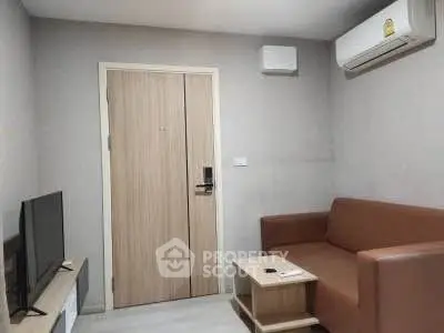 Cozy living room with modern air conditioning and sleek furniture, perfect for relaxation.