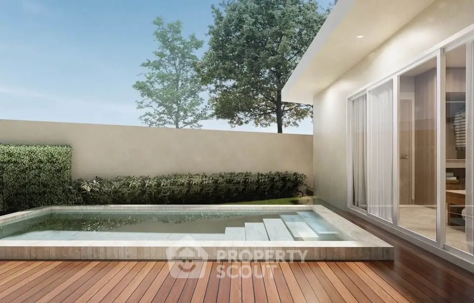 Modern home with sleek pool and wooden deck, perfect for relaxation and outdoor entertainment.