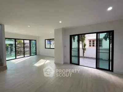 Spacious modern living room with large windows and sliding glass doors