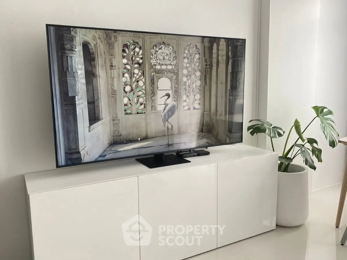 Modern living room with sleek white TV stand and elegant decor