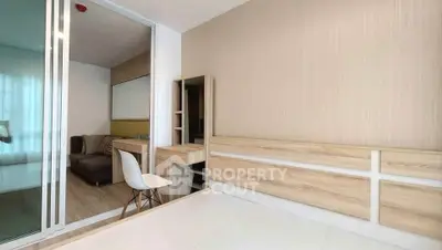 Modern bedroom with minimalist design and sliding glass doors leading to a cozy living area.