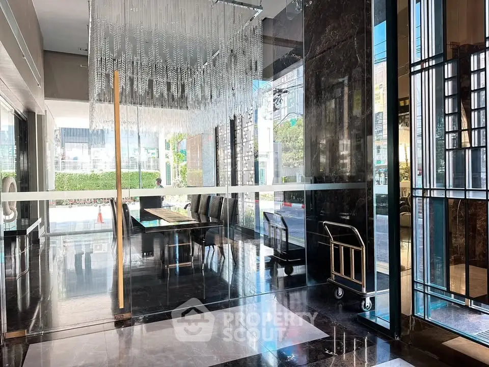 Luxurious building entrance with elegant chandelier and modern design