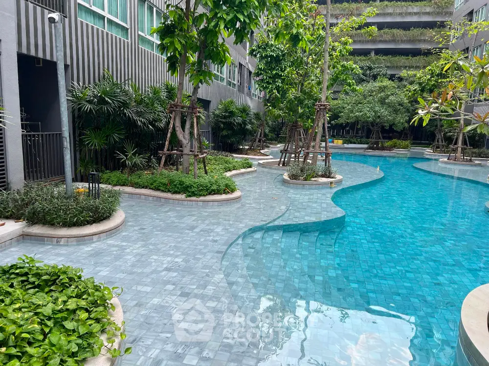 Luxurious poolside view with lush greenery in modern residential complex.