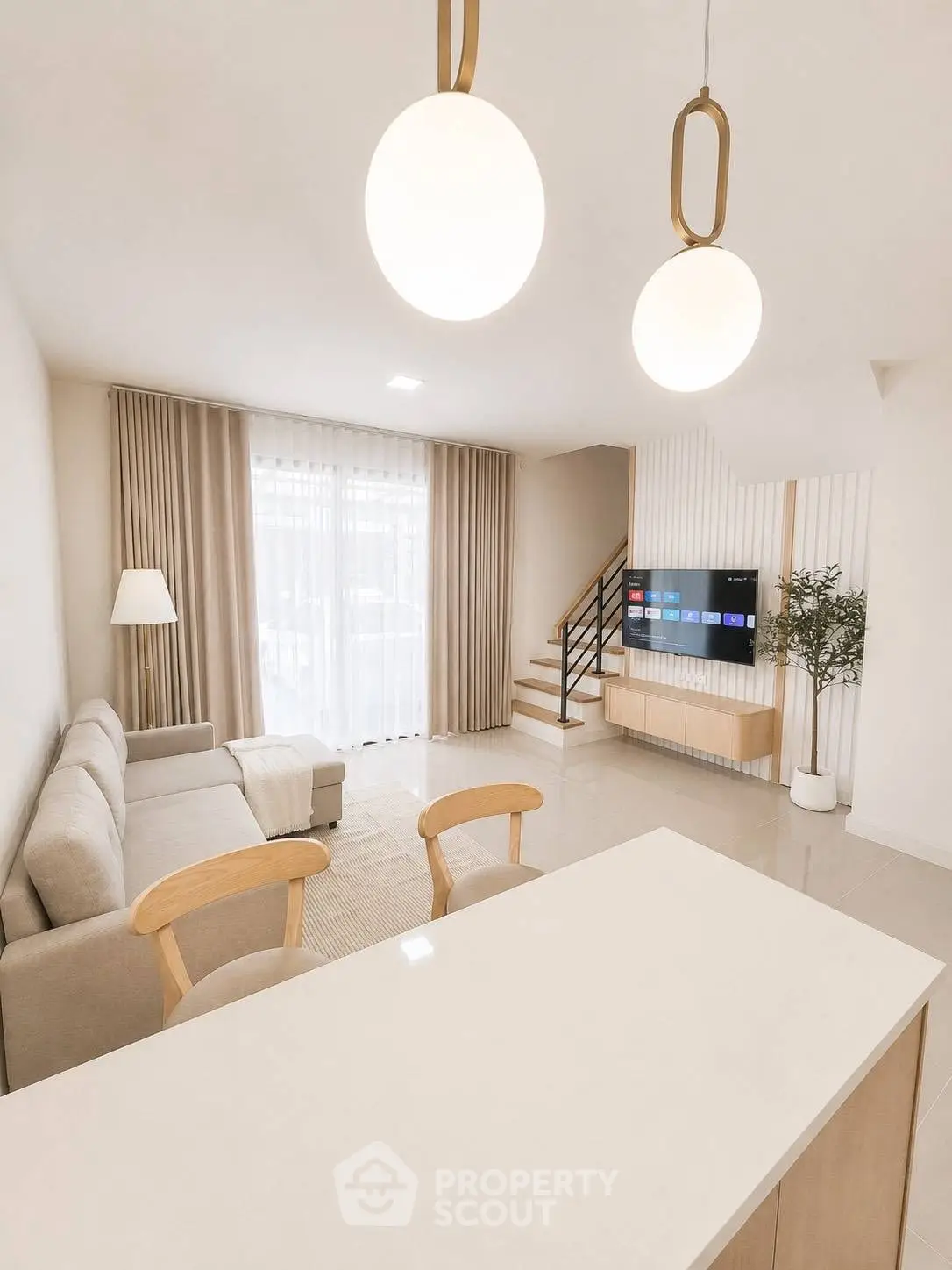 Modern living room with elegant decor and natural light, featuring a cozy sofa and stylish lighting.