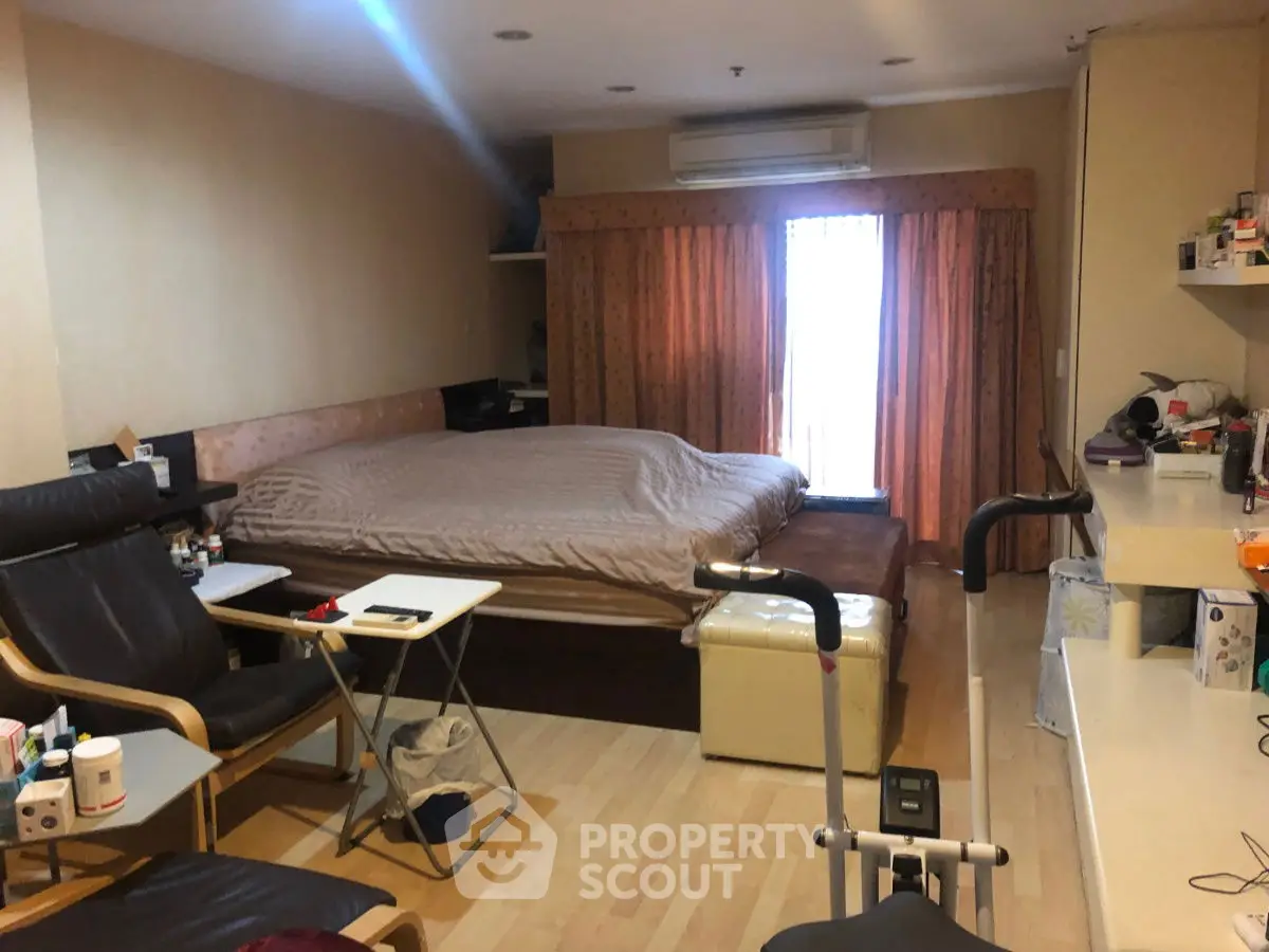 Cozy bedroom with large bed and exercise equipment, perfect for relaxation and fitness.