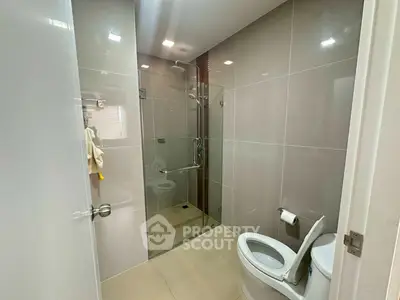 Modern bathroom with glass shower and sleek tile design