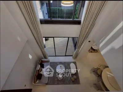 Stunning high-ceiling living room with modern decor and large windows