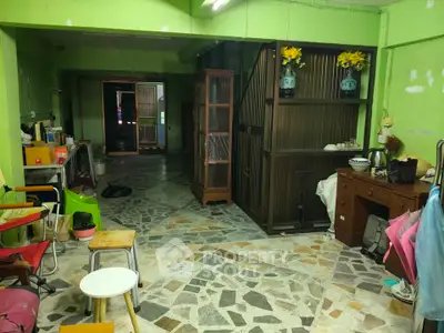 Spacious interior with unique stone flooring and vibrant green walls, ideal for creative renovation.