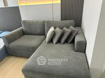 Modern living room with stylish gray sectional sofa and decorative pillows