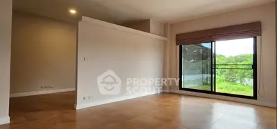 Spacious modern living room with large window and scenic view