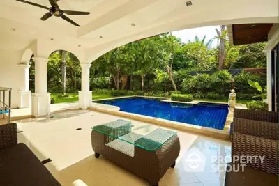 Luxurious villa with private pool and lush garden view, perfect for relaxation and entertainment.