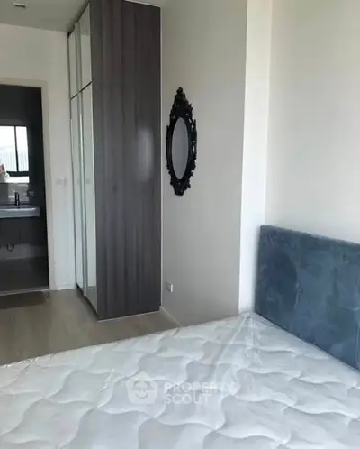 Modern bedroom with stylish decor and adjacent bathroom view