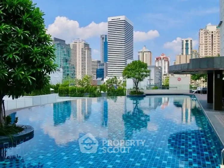 Luxurious rooftop pool with stunning city skyline view, perfect for relaxation and leisure.