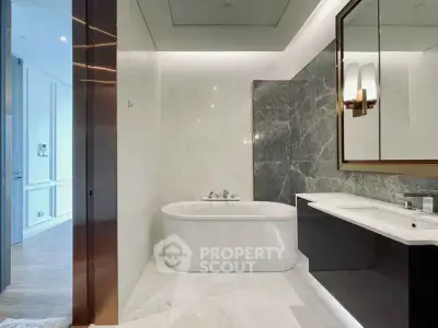 Luxurious modern bathroom with elegant marble finishes and stylish bathtub.