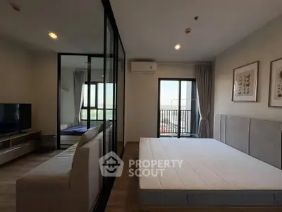 Modern bedroom with balcony view and stylish decor in a contemporary apartment.
