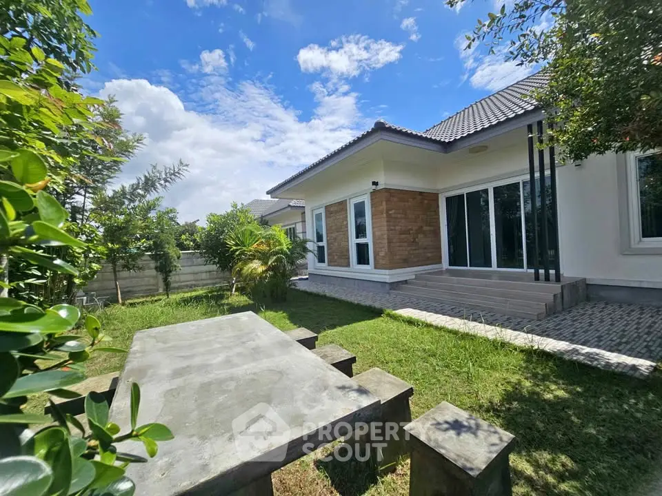 Charming suburban home with lush garden and patio, perfect for outdoor relaxation.