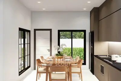 Modern kitchen with sleek cabinetry and dining area, featuring natural light and contemporary design.