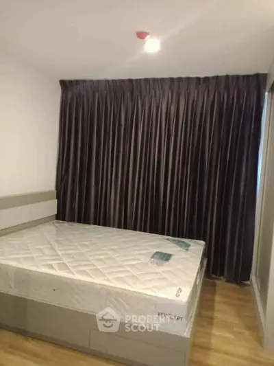 Modern bedroom with sleek design and cozy ambiance, featuring a comfortable bed and elegant curtains.