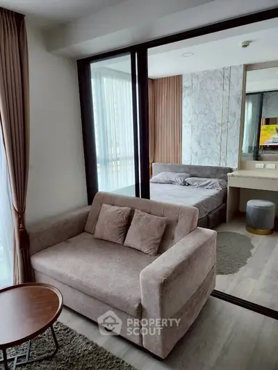 Modern studio apartment with cozy living area and stylish bedroom