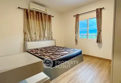 Cozy bedroom with scenic window view and modern furnishings