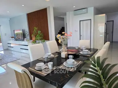 Modern dining area with elegant table setting in a spacious open-plan living room.