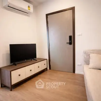 Cozy living room with modern TV stand and air conditioning in a stylish apartment.