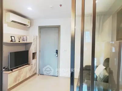 Modern living room with sleek design, featuring a TV, air conditioning, and stylish decor.