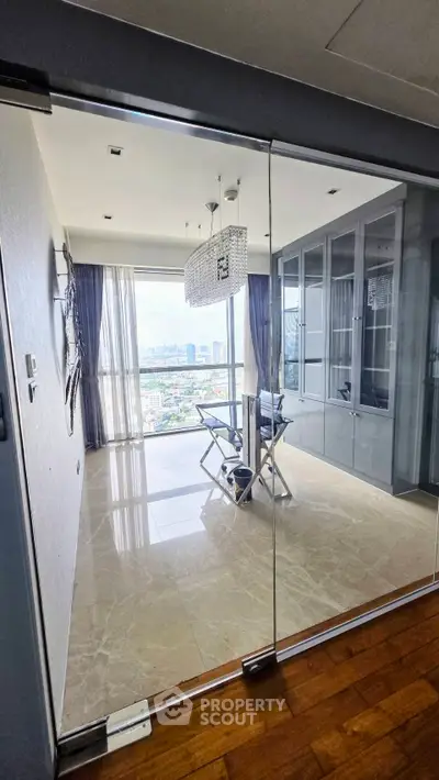 Luxurious modern living room with stunning city view and elegant chandelier