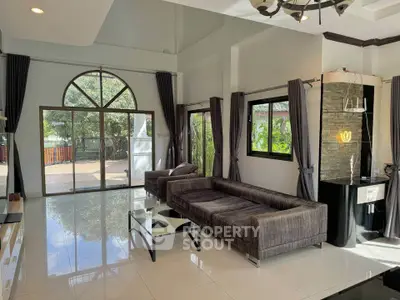 Spacious modern living room with large windows and stylish furniture