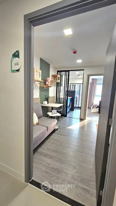 Modern apartment entrance with stylish living room and open layout
