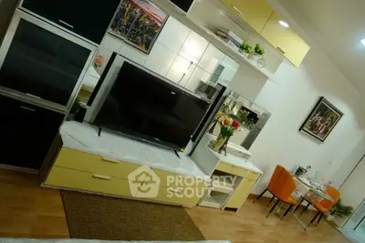 Modern living room with stylish furniture and dining area, featuring a sleek TV setup and vibrant decor.