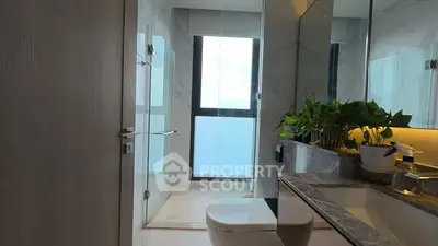 Modern bathroom with sleek design and large window view.