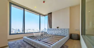 Spacious bedroom with panoramic city view and modern decor