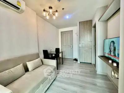 Modern living room with cozy sofa, dining area, and wall-mounted TV in stylish apartment.