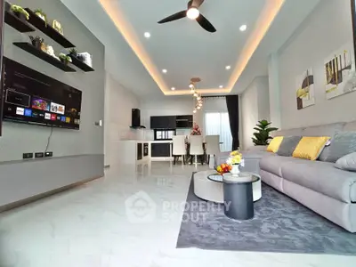 Modern open-plan living room with sleek decor and stylish lighting