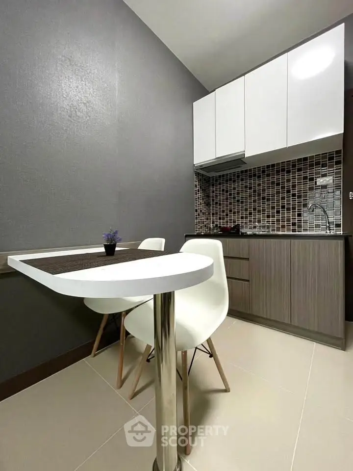 Modern compact kitchen with sleek cabinets and stylish dining area