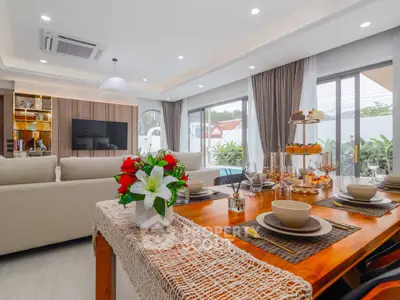 Spacious modern living room with elegant dining area and large windows for natural light.