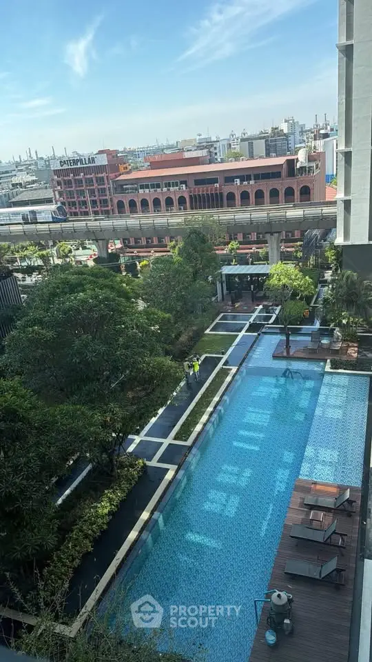 Luxurious urban apartment with stunning pool view and lush greenery, perfect for modern living.