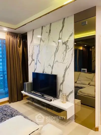 Luxurious living room with marble accent wall and modern TV setup
