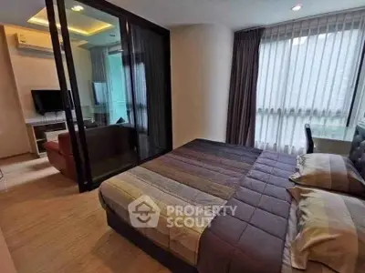 Modern bedroom with glass partition and cozy decor