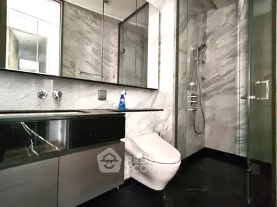 Luxurious modern bathroom with marble walls and sleek fixtures